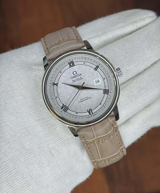 "Omega De Ville automatic men's watch with stainless steel case and leather strap"  "Omega De Ville elegant silver-tone watch with date display and round dial"  "Omega De Ville classic watch with blue dial and stainless steel bracelet"  