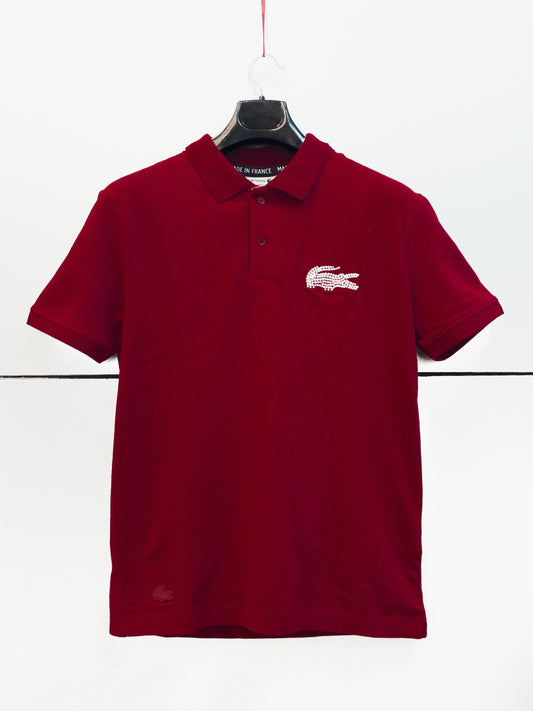 "Lacoste men's classic fit red polo T-shirt with crocodile logo." "Lacoste women's slim-fit red polo T-shirt featuring the iconic crocodile emblem."
