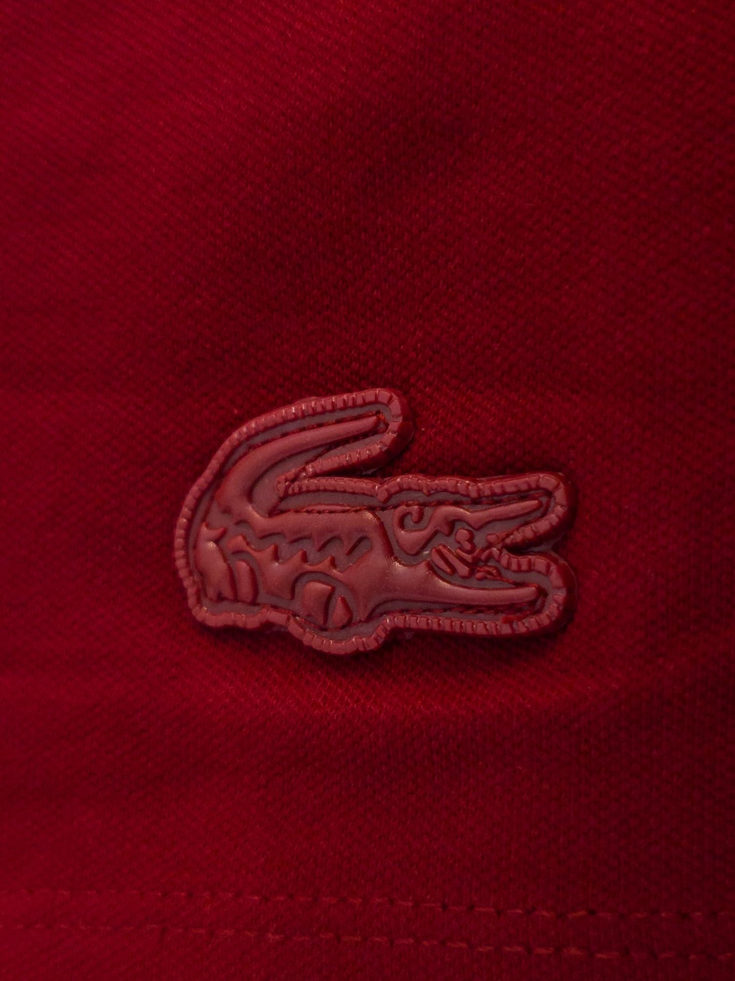 "Classic red Lacoste polo T-shirt, ideal for casual or semi-formal occasions." "Lacoste red polo shirt, perfect for everyday wear or sports activities." "Lacoste summer collection red polo T-shirt, lightweight and comfortable." 
