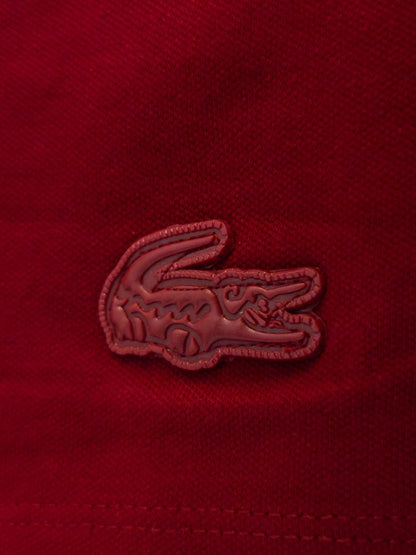 "Classic red Lacoste polo T-shirt, ideal for casual or semi-formal occasions." "Lacoste red polo shirt, perfect for everyday wear or sports activities." "Lacoste summer collection red polo T-shirt, lightweight and comfortable." 
